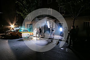 Behind the scenes of a Television advert Film Set on location in city neighbourhood with a mixed couple as models
