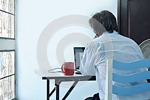 Behind shoot of business people are working with computer laptop in office area. Work at home concept