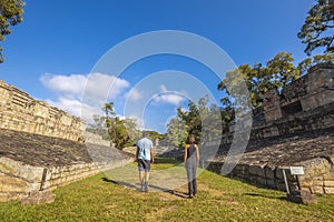 Behind shot of the tourists visiting Copan Ruinas and its beautiful Mayan ruins in Honduras