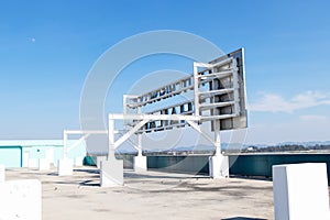 Behind Steel color white structure billboard frame for large located on roof of building.