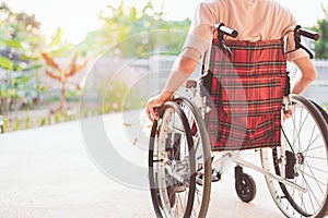 A young man in a wheelchair pushes his own car with confidence