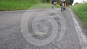 Behind young man swerving with his bicycle in the middle of the runpath.