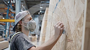 A behindthescenes image of a worker applying ecofriendly finishes to a prefab panel emphasizing the craftsmanship and