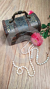 Wooden chest with white pearls and flowers