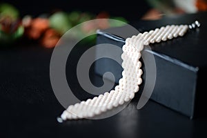 Beige beaded bracelet on a darck background