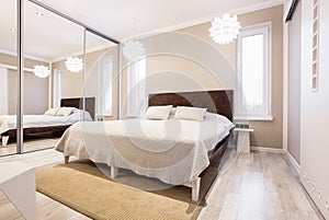 Beige bedroom with mirror wardrobe photo