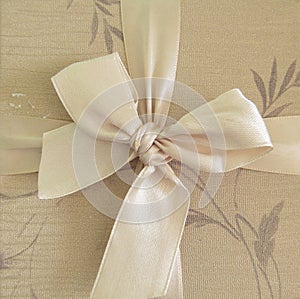 beige bow tied on the box