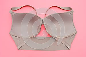 Beige bra for women on pink background