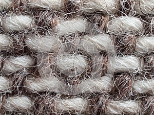 Beige-brown woven fabric, an example of craftsmanship, detail