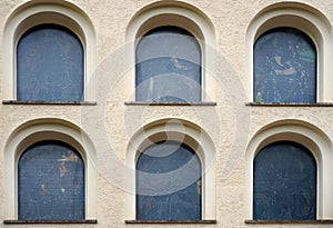 Beige building with many black windows