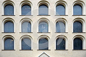 Beige building with many black windows