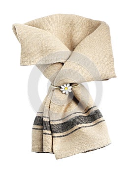 Beige cloth napkin with decorative ring for table setting isolated on white, top view