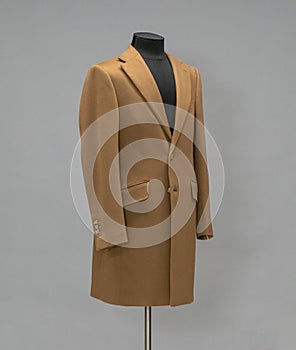 Beige coat on a mannequin in the studio