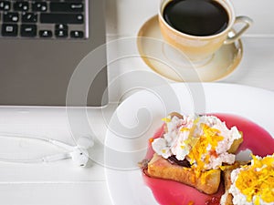 Beige coffee Cup and toasted French bread with curd cream, plum jam and orange zest.