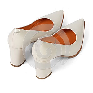 Beige comfortable office women's shoes with black sole with thick heels and a sharp nose on a white background