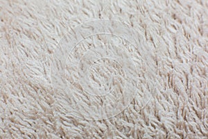 Beige cotton towel or carpet.fluffy texture background. Close up, macro photo. Soft focus image
