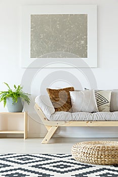 Beige couch, pouf and plants