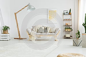 Beige coverlet lying on grey sofa photo