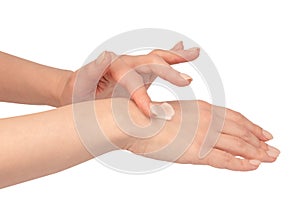 Beige cream tube in woman hands isolated on a white background. Cream swatch on woman hand