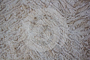 Beige curly soft and artistic fur textured background with waves