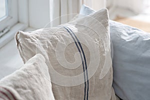 Beige cushion with blue stripe