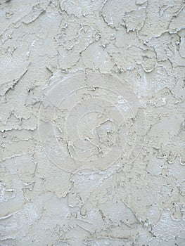 Beige decorative plaster on the facade of the building. Abstract grunge decorative stucco wall texture. Rough background with copy