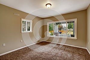 Beige empty room with brown carpet floor