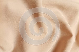 Beige galliano fabric crumpled or wavy fabric texture background. Abstract linen cloth soft waves. Viscose yarn. Smooth photo