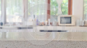 beige glossy terrazzo stone table top on blur cafe minimal kitchen counter at background.