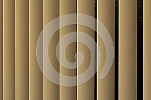 Beige or golden 3d stripes on black background. Louvre shutters like pattern.