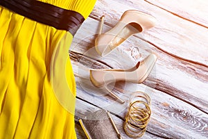 Beige heels and yellow dress.