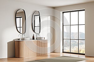 Beige hotel bathroom interior with double sink and accessories, window