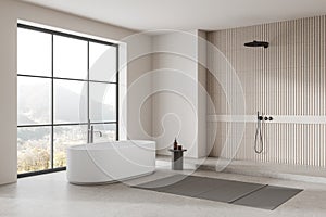 Beige hotel bathroom interior with tub, douche and panoramic window