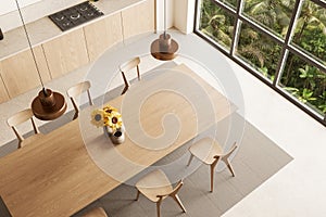 Beige kitchen interior with cabinets and dining table, top view