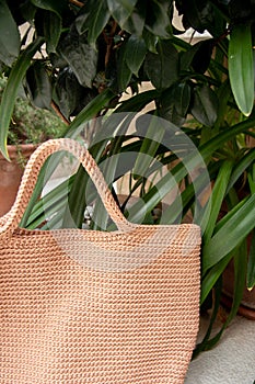 Beige knitted bag handmade outdoors. Sustainable shopping. Waste-free lifestyle