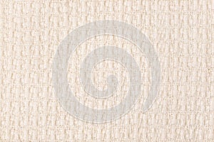 Beige knitted fabric texture background. Close-up