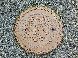 Beige manhole cover. Top view.