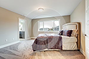 Beige master bedroom with king size bed