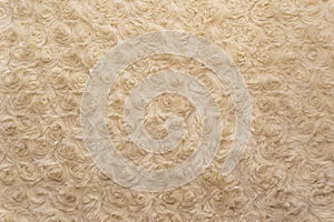 Beige natural wool with twists texture background. Cotton wool, white fleece carpet. White fur rug with pattern