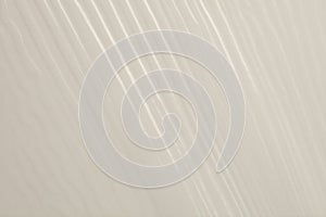 Beige paper and cellophane texture wave background