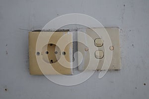 Beige plug socket and switch at home