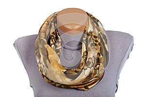 Beige scarf on mannequin isolated on white background.
