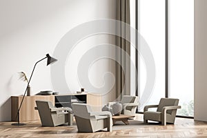 Beige seating area with four armchairs and accent lamp. Corner view