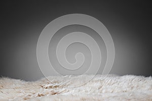 Beige sheepskin texture on gray background