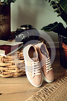 Beige shoes elegant leather women`s shoes on a wooden background light shiny shoes with heels.