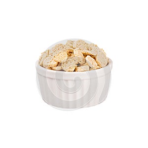Beige sliced wheat bread as croutons in white ceramics bowl isolated on white background.