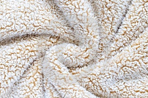 Beige soft plush fabric of cozy plush throw