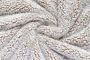 Beige soft plush fabric of cozy plush throw