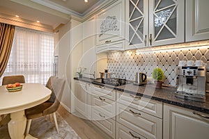 Classic beige spacious kitchen with a classic aesthetic and modern conveniences