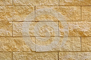 Beige stone blocks in the wall
